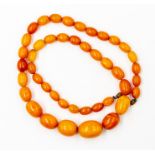 A butterscotch a amber type bead necklace, comprising oval beads, measuring from approx. 12mm x