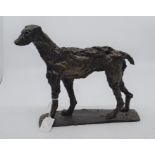 A bronze depiction of a greyhound like dog, abstract, missing half of tail