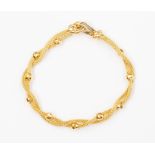 An 18ct gold Italian woven link bracelet, comprising a double twisted row and alternate faceted bead