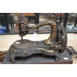 A late Victorian cast iron sewing machine, gilt decoration throughout, hand powered