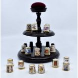 17 Royal Crown Derby thimbles in boxes with stands and a collection of thimbles book. 2 bags.