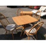 An Ercol Windsor light elm and ash dining suite, comprising four stick back chairs, with elm seats