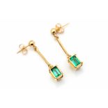 A pair of emerald and yellow gold drop earrings, comprising rub-over set emerald-cut emeralds,