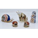 Five Royal Crown Derby paperweights in the form of a polar bear, two ladybirds, snail and a