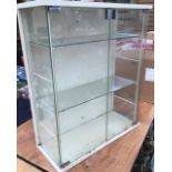 Display cabinets: one with double doors and two glass shelves, 72cm tall 61cmwide, 25cm deep, one