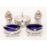 A collection of assorted silver condiments, comprising a pair of George VI classical shaped