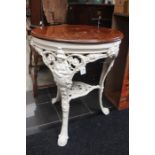 A traditional cast iron pub table, possibly Victorian, the mahogany top raised on a cast iron frame,