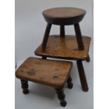 Two early 19th Century elm footstools and a later Victorian elm topped footstool raised on turned