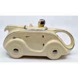 A circa 1930's racing car shaped teapot. Length approx 23cm, Height approx 11cm, Width approx