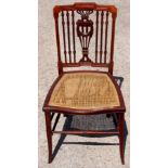 An Edwardian mahogany bedroom chair, having a carved and pierced back splat