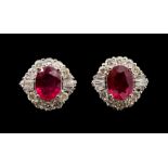 A pair of ruby and diamond 18ct white gold cluster studs earrings,  comprising oval rubies claw