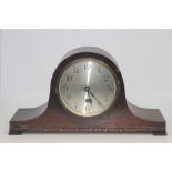 A George V oak mantle clock, Arabic numerals on a silvered dial, Napoleon shaped case