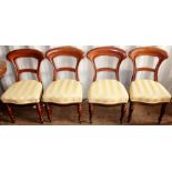 A set of four Victorian mahogany balloon back chairs, standing on turned legs, upholstered seats (