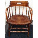 An early 20th Century ash and elm seated captains chair, circa 1920, having a saddle seat, 78cm