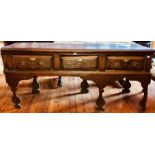 A late 17th century oak dresser base, circa 1690, moulded top, three frieze drawers with brass