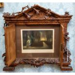 A late 19th Century Black Forest carved wooden wall mounted frame, circa 1880, of architectural form