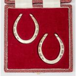 A pair of miniature horse shoes, maker FH, London, approx 1.69ozt, cased