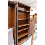 A pair of birchwood veneered open bookcases, of recent manufacture, each complete with five