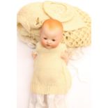An Armand Marseille bisque head baby doll, sleeping eyes, open mouth