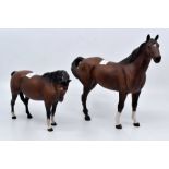 Four Beswick horses, two bay, palomino and a dapple grey Condition: Broken, repaired leg and ear