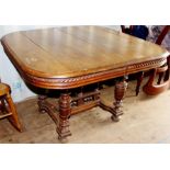 A Victorian Renaissance Revival oak dining table, having a central support section