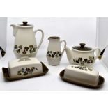 A collection of Denby, Clover pattern tea wares, including teapot, coffee pot, mugs, butter dish etc