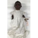 A bisque head Armand Marseille black doll, open eyes, open mouth, revealing two top teeth, measuring
