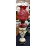 A late 19th Century ruby glass and enamelled oil lamp along with three Victorian hand painted