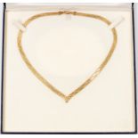 A 9ct gold Italian necklace, wishbone shaped, flat snake style with engraved decoration,  length