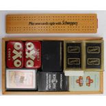 A tray of assorted items, including playing cards, badges, cribbage board etc