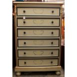 A contemporary cream painted chest of drawers, comprising six long drawers, decorated with hand