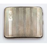 A George V oblong cigarette case, engine turned decorated, with monogram, gilt decoration, by London