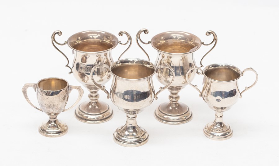 A pair of modern silver two handled small trophies, Birmingham, 1956 together with three further