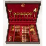 A 1960's canteen of cutlery with gold plated and mahogany handles