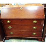 A George III mahogany bureau, circa 1800, the fall front opening to reveal a fitted interior, with a