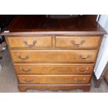 A Georgian style mahogany chest of drawers, having two short over three long graduated drawers,
