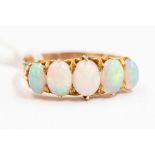 An opal and 14ct gold ring, set with five graduated oval opals, claw set,  size V, unmarked, total