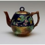 A nineteenth century Majolica teapot and cover, circa 1870. It is moulded with basket weave with