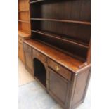 A George III oak dresser and rack, circa 1780, the rack with three plate shelves, the base section