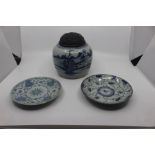 A Chinese blue and white ginger jar and cover, hand painted, the ebony lid carved throughout, 18cm