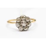 A diamond and 18ct gold and platinum flower cluster ring, set with old cut diamonds, head approx.