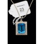 An 18ct white gold blue topaz and diamond pendant, the substantial rectangular cut-cornered step cut