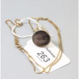 A Middle Eastern intaglio engraved seal, on an associated 9ct gold box link chain