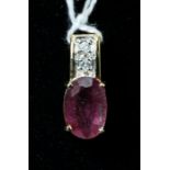 A ruby and diamond pendant, the oval cut ruby in four claw mount, on two stone diamond set, 18ct gol