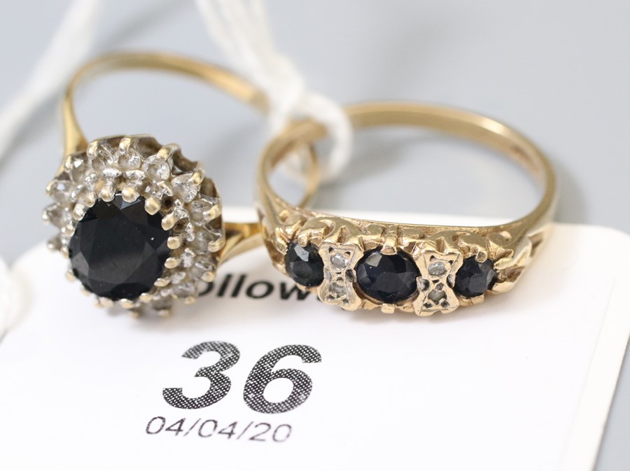 A sapphire and diamond seven half hoop ring, in pierced scrolling 9ct gold mount and a sapphire clus