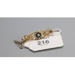 An Art Nouveau turquoise and split pearl bar brooch, pierced scrolling frame with central flowerhead