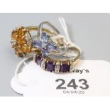 A tanzanite cluster ring, in 18ct white gold mount, an amethyst and diamond half hoop ring in 9ct mo