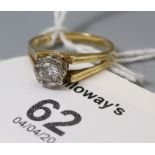 A single stone diamond ring, the brilliant cud diamond in illusion mount, to bifurcated 18ct gold sh
