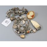 A substantial silver charm bracelet, suspending numerous charms, another similar, a 9ct gold locket