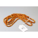 An amber bead long chain of small oblong beads, vari-coloured, approximately 156cm length gross weig
